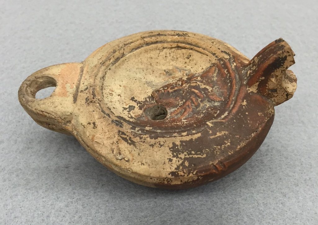 Object ID 1902.722.8: Roman-style oil lamp produced between the 1st and 5th centuries; collected in Greece circa 1860-61 by Professor James Cooke Van Benschoten and donated in 1902 by Mrs. Van Benschoten.